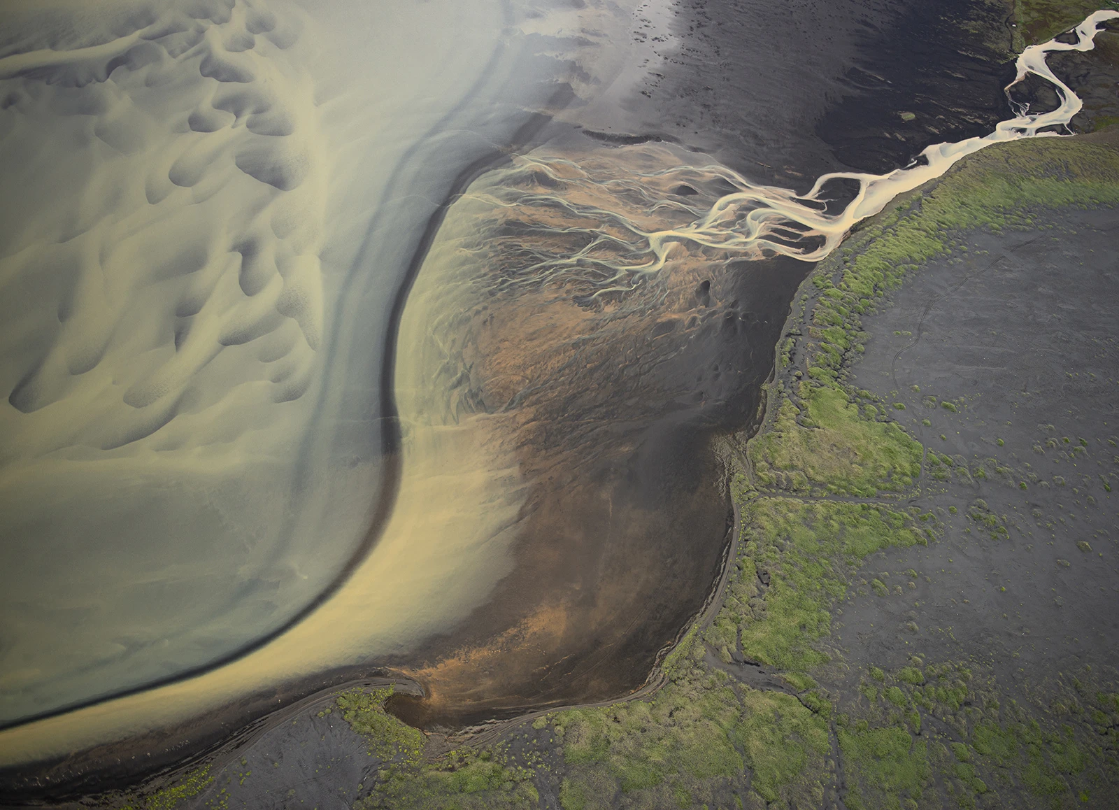 Effluent patterns enetering the sea, Iceland – photo by Reiner Boehme