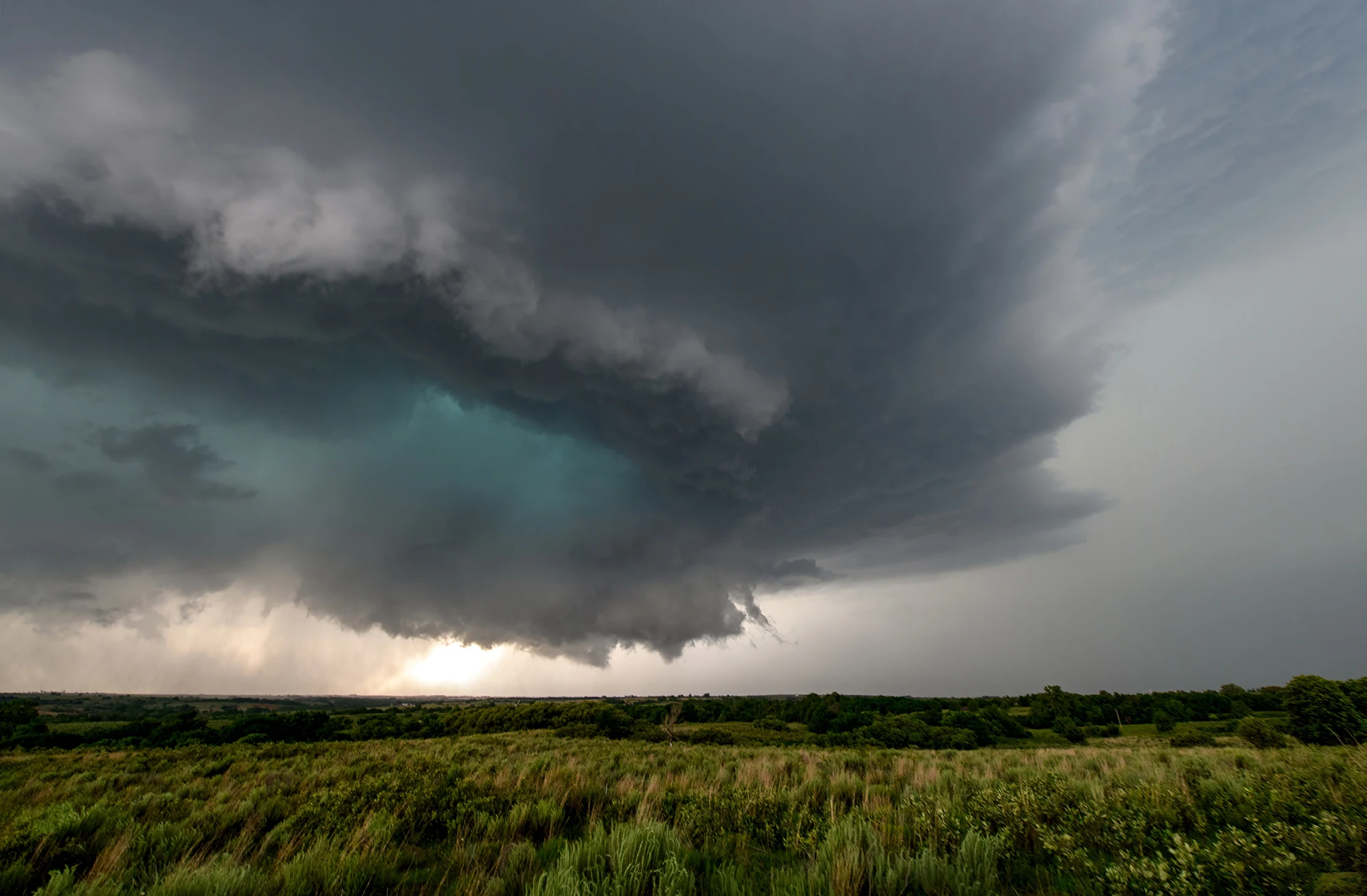Green color caused by sunrays behind hail, Tornado alley 2024 – photo by Reiner Boehme
